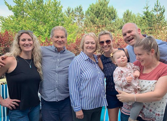 35 years old, Lauren with her parents and siblings, enjoying a happy life.